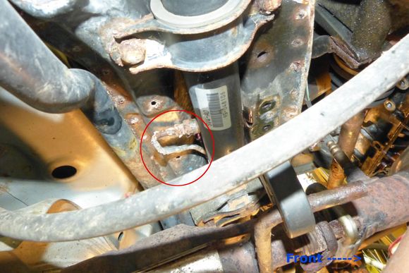 It's above the catalytic converter tucked under the rear cross member.