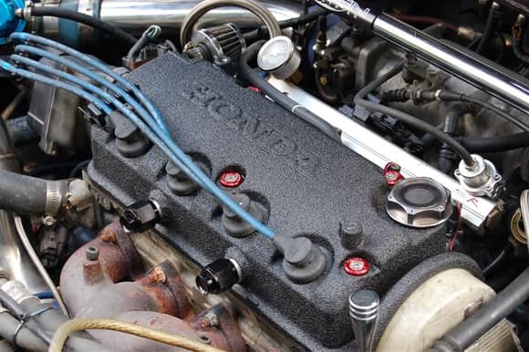 In this picture; DSM 450cc injectors, PWD:JDM valve cover washers, limited run vented oil cap, Vented valve cover, OBX fuel rail, FPR and liquid filled gauge. Braided fuel line.