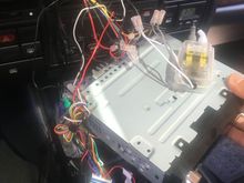 The blue unit is the steering wheel remote interface. The clear units are inline crossovers. All in all, it makes for a pretty crammed installation due to that bracket. 