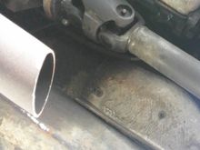 Exhaust pipe below excised cat converter.