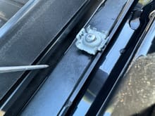 DRAIN CHANNEL: Using a pointer to show the drain channel. This is drivers side of car. That metal clip is what holds the trim strip down. 