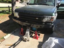 Using jack stands and a jack to align new bumper in place