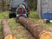 P5131485 This was the largest log so it was carried by itself this is my pal Lenny who owns the logs.
