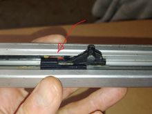 The arrow points to the square track bushing, the pin on the cable boss runs in one and the pin in the glass carrier runs in the other (not shown).  90% of the time the pin on the cable boss breaks off.