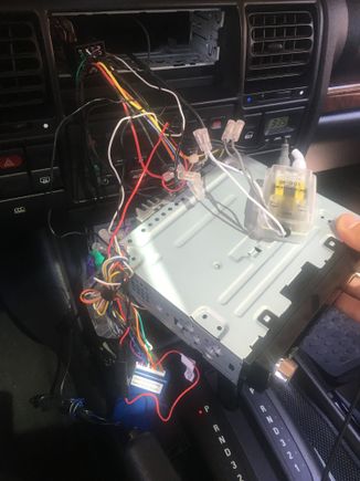 The blue unit is the steering wheel remote interface. The clear units are inline crossovers. All in all, it makes for a pretty crammed installation due to that bracket. 