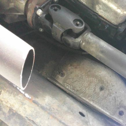 Exhaust pipe below excised cat converter.