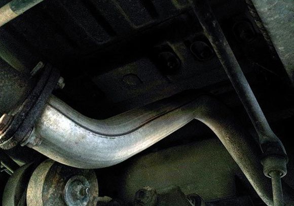 Exhaust pipe, bent from being rear-ended by an uninsured text-messaging 25-year old, who has agreed to pay for this and a new rear bumper. Her Volvo X70 caught my trailer hitch in the middle of its radiator.