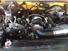 Here is the engine in running condition.  The yellow on the firewall was the original truck color.  Dirty Dingo relocation brackets and corvette accessories.