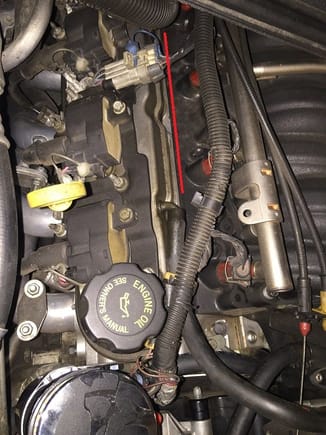 the purpose of this photo is to show how much cleaner the passenger side valve cover area is without all those hoses.  the red line indicates the area where hoses were routed from the factory