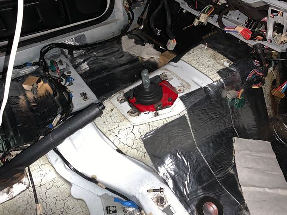 The whole Tremec shifter assembly was contacting the coupe's transmission tunnel.  I did some online research and found that the tunnels on manual transmission cars were modified.
