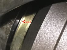 The red arrow points to a raised area on the seal.   Is the seal fully mounted into the transmission casing?