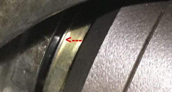 The red arrow points to a raised area on the seal.   Is the seal fully mounted into the transmission casing?