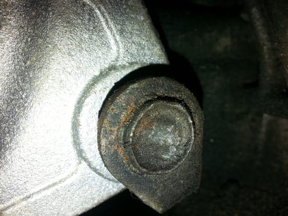 Once the compressor is removed you can get right in there and get things done fast. As you can see by the end of this bolt, its not tight. The bar at the bottom of the bolt should be twisted against the body of the alternator.