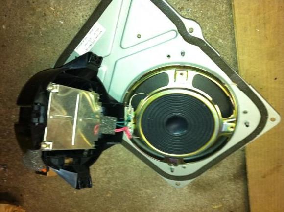 Remove 3 screws holding down black housing to subwoofer, then remove 4 screws from metal box to remove box from the housing.