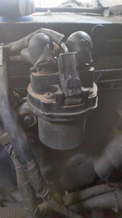 I think it's in the boot behind the battery 