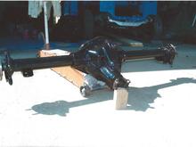 Keeping it all Mopar. This is a '99 Ram 1 Ton van rear end with 4.10 posi. Unit was cut to fit the DeSoto body and track. Curry axles were added and Ford racing rear disc brakes.