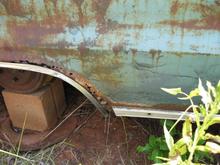 Rust damaged lower rear quarter