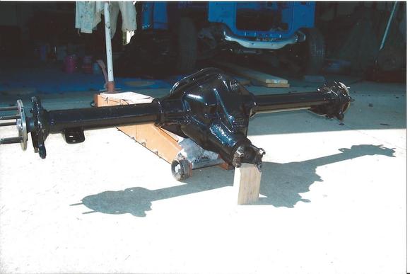 Keeping it all Mopar. This is a '99 Ram 1 Ton van rear end with 4.10 posi. Unit was cut to fit the DeSoto body and track. Curry axles were added and Ford racing rear disc brakes.