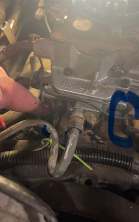 Where my finger is pointing and the blue circle shows the two small line attached.  There is a larger vacuum line between two. 