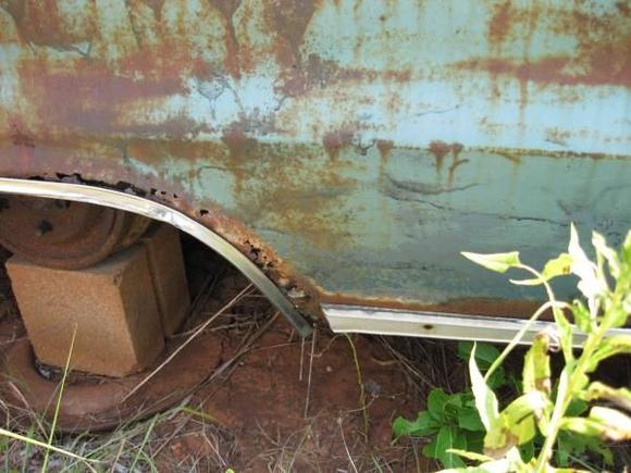 Rust damaged lower rear quarter