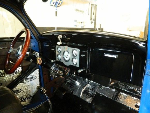 Lets see, Grant banjo steering wheel, Stewart Warner gauges in a custom panel made for my by a friend at FedEx, Moon tach, Hurst ProMatic II shifter, a Vintage Air hvac hanging just below and in the glove box, a/c controls, Kenwood stereo and an aux power port. What we used to call a cigarette lighter...
