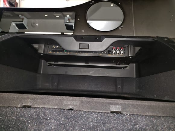 With the amp mounted to the underside of the rear speaker "tower", it is up and out of the way, so that there is still room for items in the glovebox, when needed.