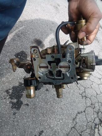 The piece lays underneath the carb