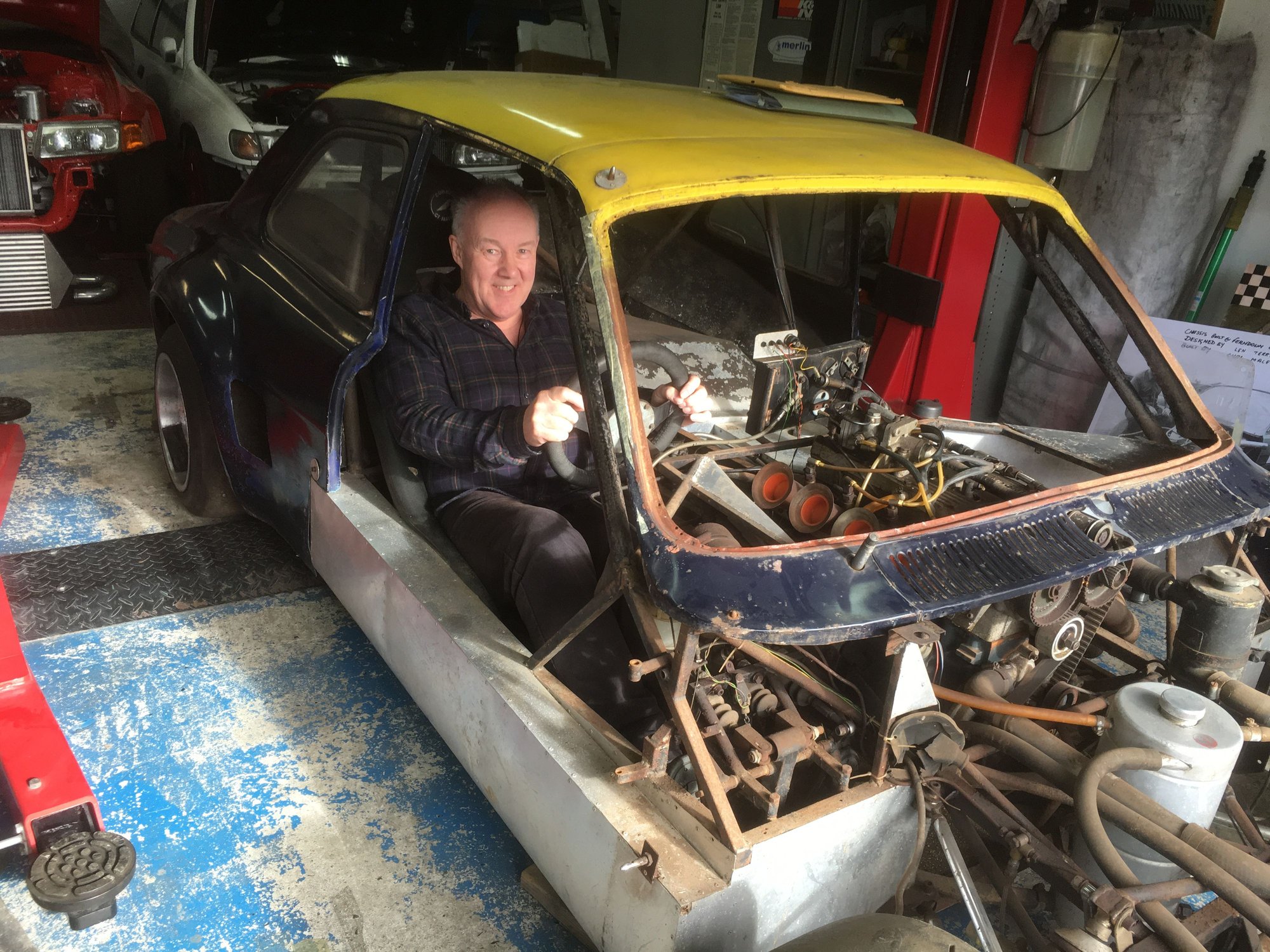 Graham Wood sitting in his dads old car that he had not seen for fifty years.