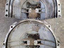 Early upper bell housing on the bottom, late model up top.
