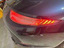 Passenger side clear tail light, on. 