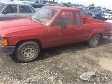 Stock photo of red 84 Toyota pickup extra cab