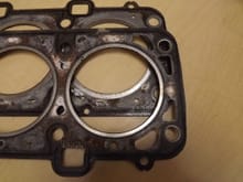 Top and bottom of 5.0 head gasket, for comparison of "fire ring".