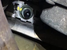 This is the passenger side nut from underneath looking straight up. This is easily accessible with an extension for your torque wrench. The rear of the car is toward the bottom of the image for reference.