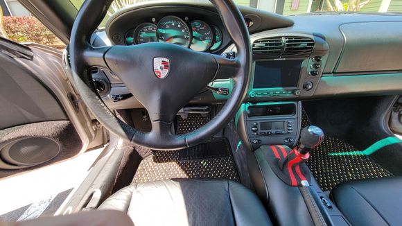 Pccm plus installed, function first shift right, raceseng knob and custom suede boot. And Coco mats, which really ties the room together, man. For me, they made a big difference, the cabin is brighter and feels larger. Not seen in this photo are black suede with red and yellow stitching belt receiver covers, black w red stitching handbrake cover, and a suede armrest cover with red accents that matches the shifter boot. Oh and a German flag wrap on the rear view mirror, which needs redoing.