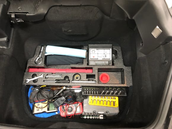 Porsche toolkit, warning triangle, air compressor, tire sealant, and a few extras. 