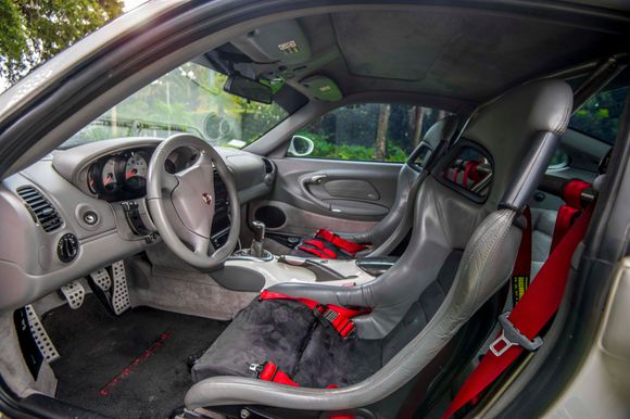 Stock recaro Porsche Crest Seats. Alcantara inserts were aftermarket I have the original grey leather inserts and they've seen very little use. Shifter is Porsche carbon as is the E Brake and center console. Techquipment roll/harness bar and scrothe harnesses. Porsche pedals