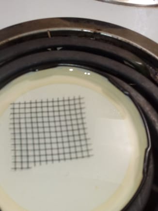 Fiberglass mesh submerged in cooking oil