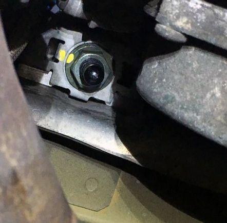 This is the passenger side nut from underneath looking straight up. This is easily accessible with an extension for your torque wrench. The rear of the car is toward the bottom of the image for reference.