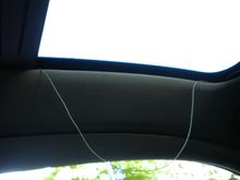 This nylon cord has been hanging out of the track and appeared to loop through something in the corner before following the windshield.