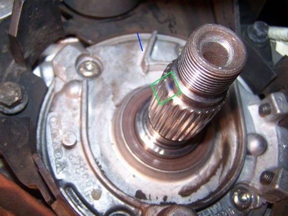 This is a view of the crankshaft bearing carrier and crankshaft end, taken from inside the right front wheel well. 
The blue line shows the location of the timing mark on the corner of the cast rib.
The green box outlines the splines on the crank which have been joined at the end to make a double spline 'key' for the timing belt pulley.