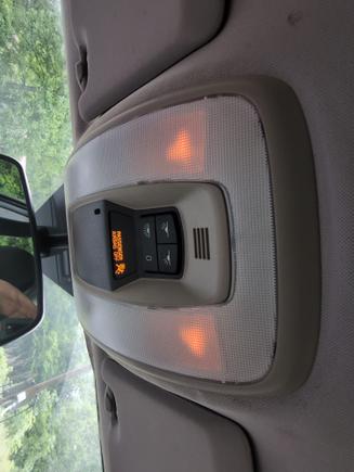 Doors are closed and in Drive.  The light should be off, but it is dimly on.