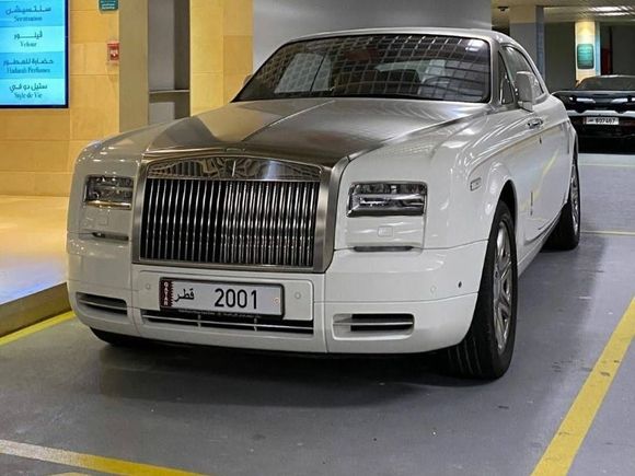 White Phantom Drophead with a Mclaren 720s in the back. 