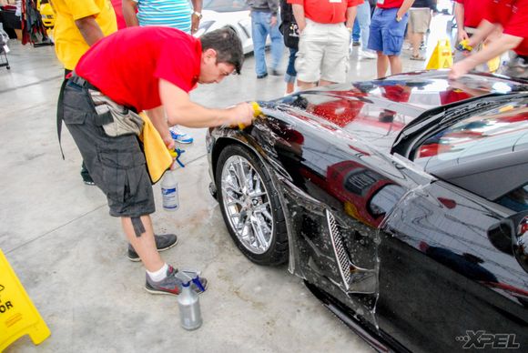 The guys from Clear Auto Bra are installing XPEL ULTIMATE on the front fenders