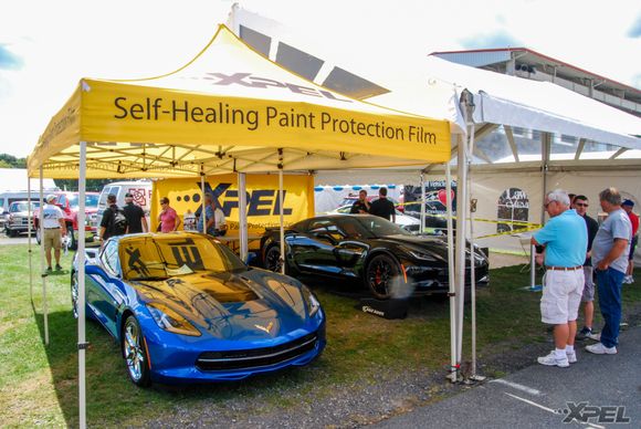 The blue Corvette is sitting under our XPEL tent, awaiting its owner to pick it up