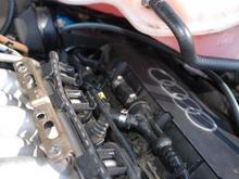 Hose Runs along top of engine.  Looks like it connects to Brake Master Cylinder