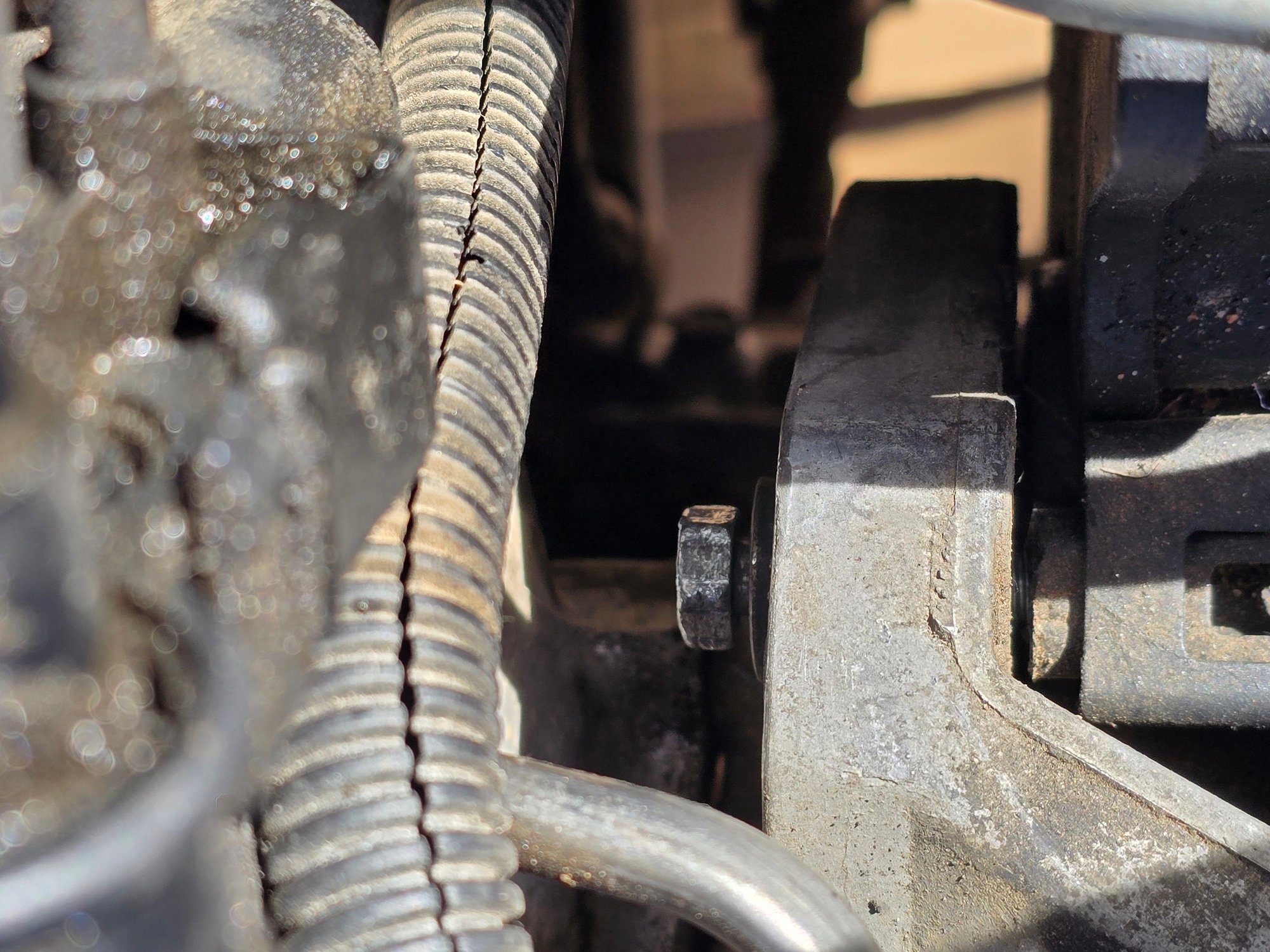 [rear view] bolt (2) on top of ps pump configuration, loosened 