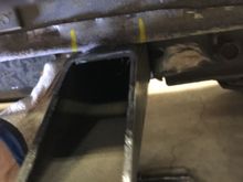 Start at the rear mount. Hold the tie in against the spring mount bracket, then mark the floor.