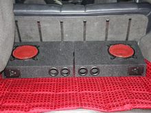 2 x 8 inch subs powered by a 600w Kenwood Amp - $free.99.

also placed a red throw blanket to add some color &amp; cover the dirty carpet. plus it matches the speaker guards on the box  =0)