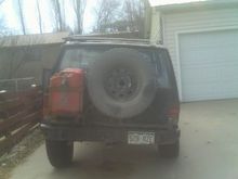 rear bumper, with spare and gas tanks on swing arm