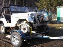 My buddy bought this the other day.  It's a 1961, I believe it's technically called a Willys, but I don't know much about these.  It has a 4 cylinder and is built like a tank.  This little thing came with a huge industrial looking plow, like something you see on a medium size municipal plow truck. Appearently it moves it with no problem.